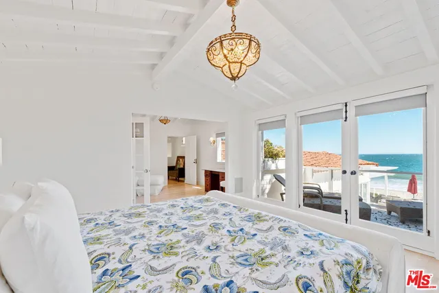 a view of a bedroom with furniture window and hardwood floor
