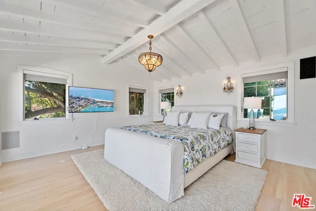 a spacious bedroom with a bed and window