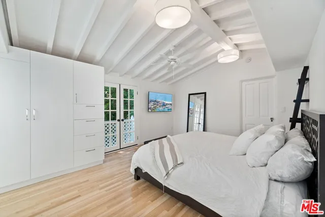 a bedroom with a bed and a large window