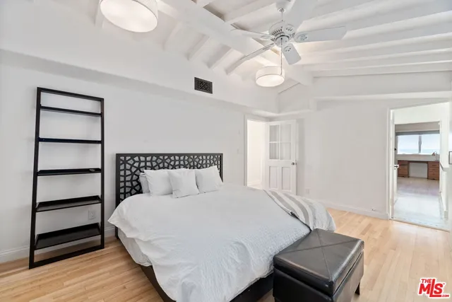 a bed room with a bed and a chandelier