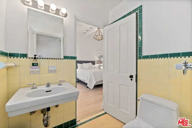 a bathroom with a sink a mirror and a shower