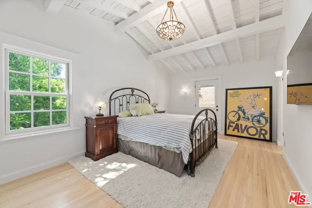 a bedroom with a bed next to a window with the outer view