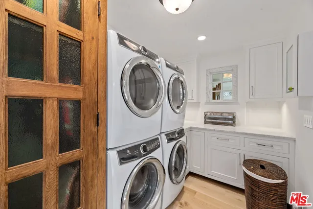 a view of a storage and utility room with dryer and washer