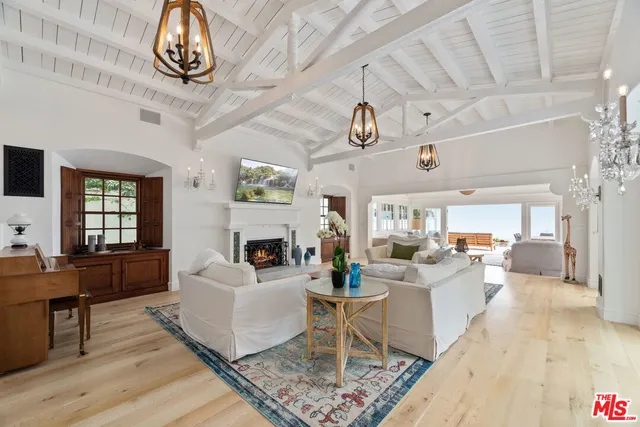 a living room with fireplace furniture and a wooden floor