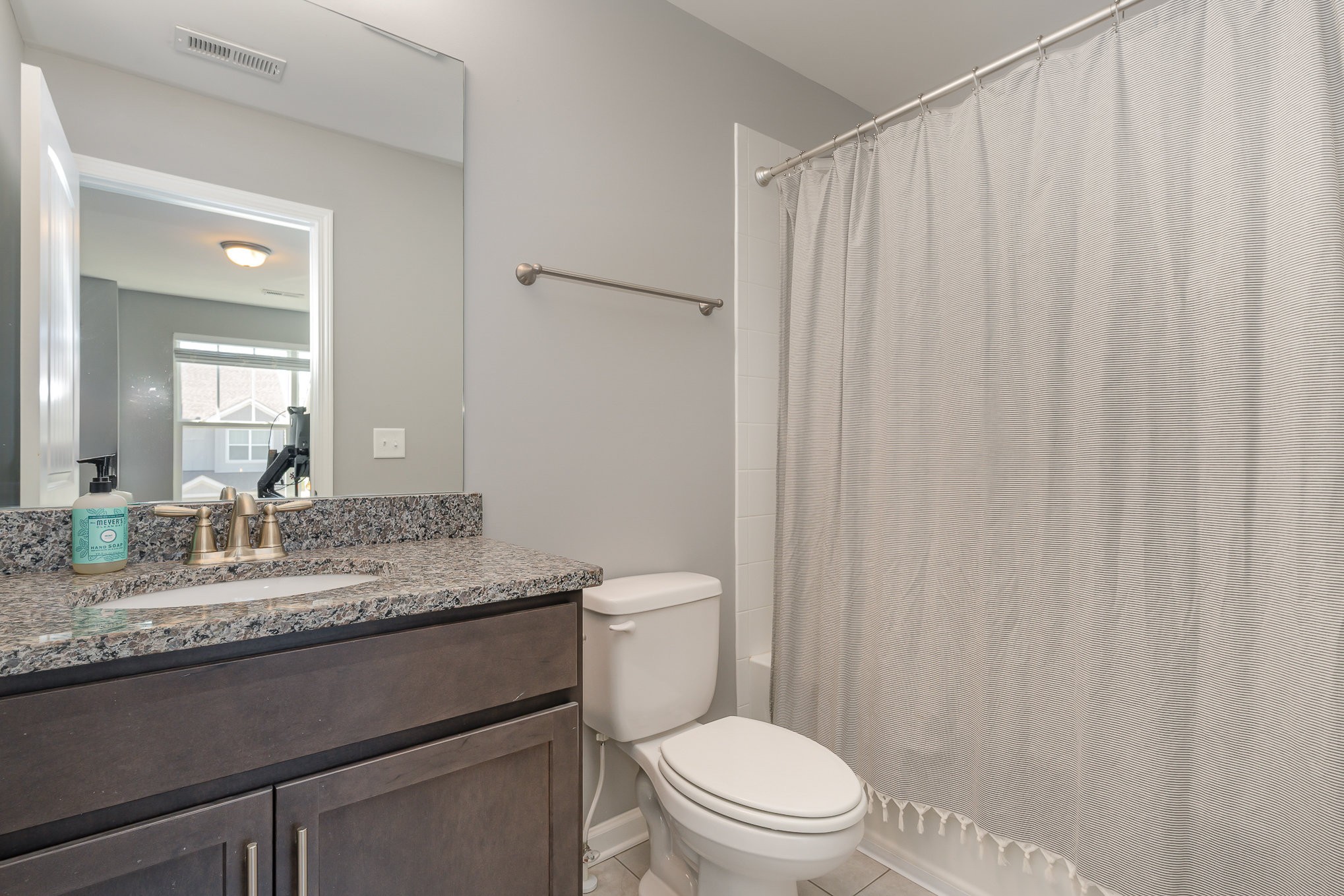 409 Bell Forge White Bluff, TN 37187 - Photo 12 of 17 a bathroom with a granite countertop sink toilet and a mirror