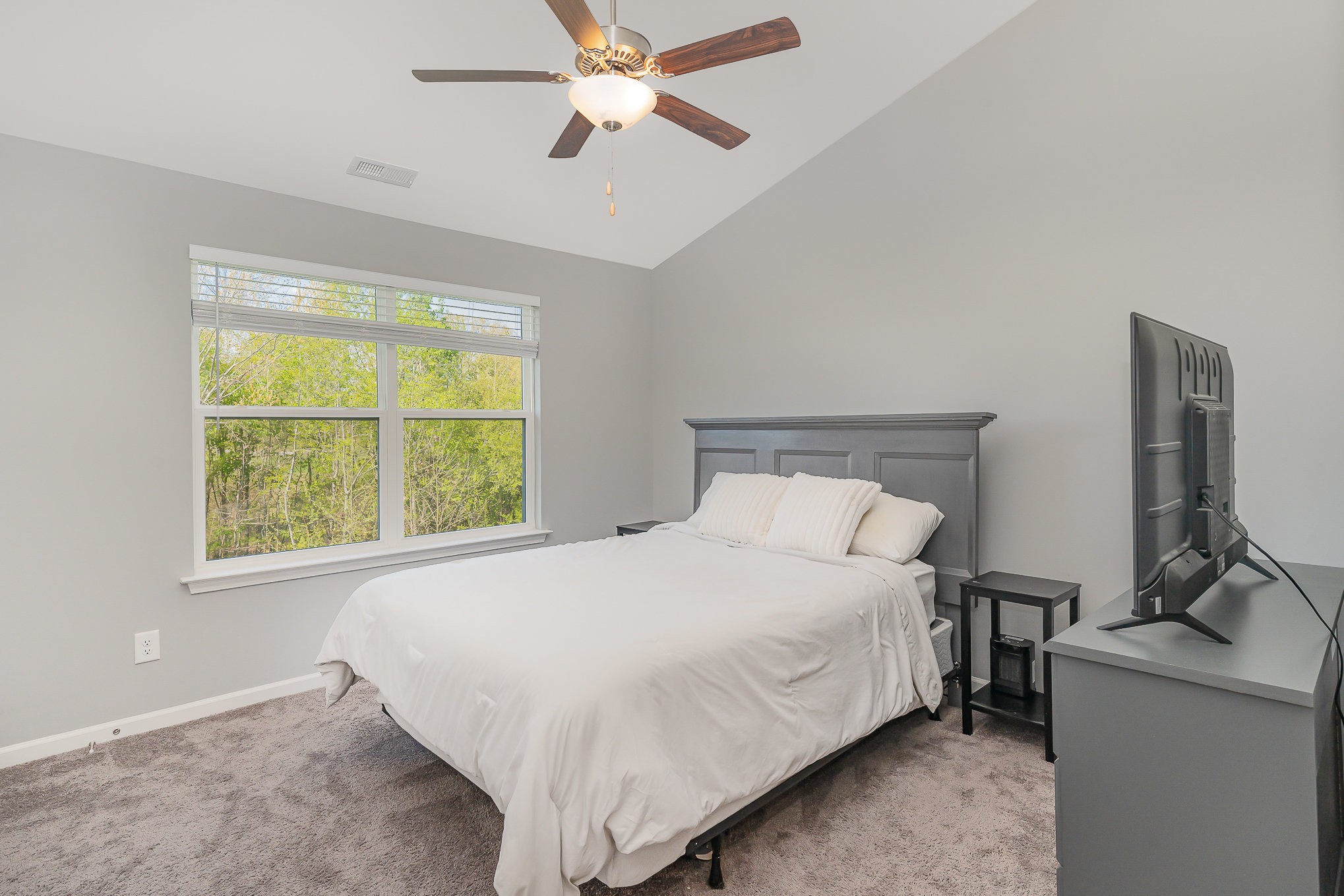 409 Bell Forge White Bluff, TN 37187 - Photo 8 of 17 a bedroom with a bed and a flat tv screen on the dresser