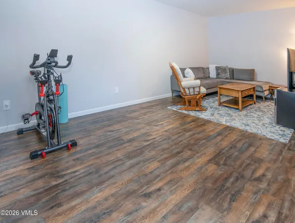 a view of a livingroom with wooden floor and stairs