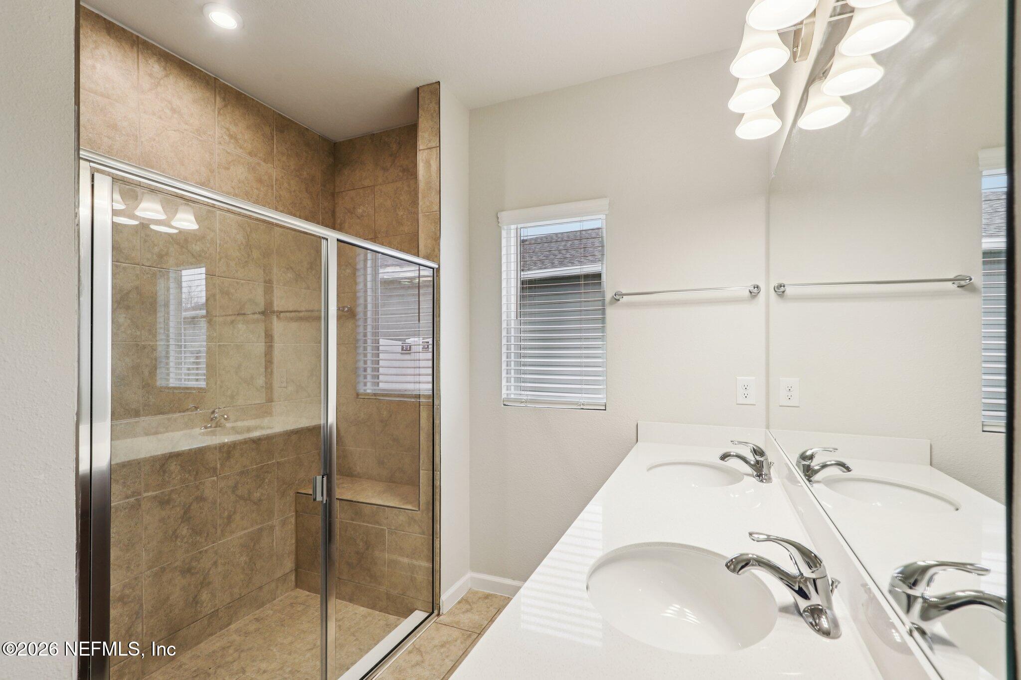 11325 Streamsong Drive Jacksonville, FL 32221 - Photo 20 of 30 a bathroom with a sink and shower