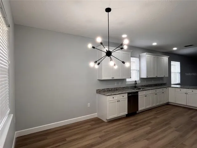 a large kitchen with stainless steel appliances kitchen island a large island in the center