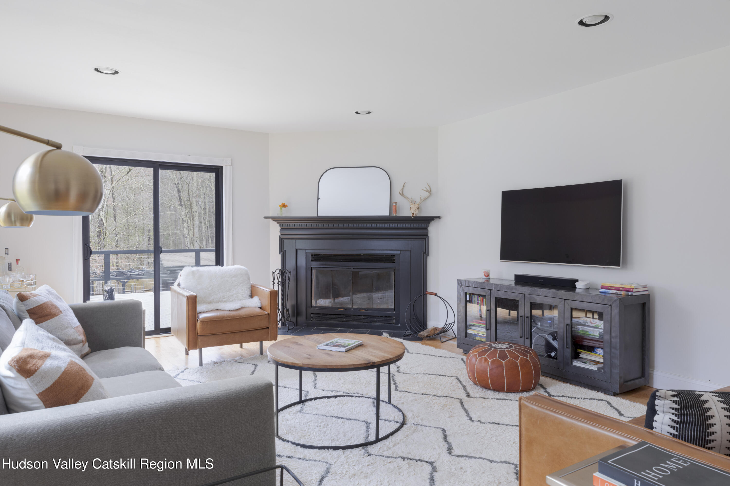 79 Stillwater Road Stone Ridge, NY 12484 - Photo 12 of 29 a living room with furniture a flat screen tv and a fireplace