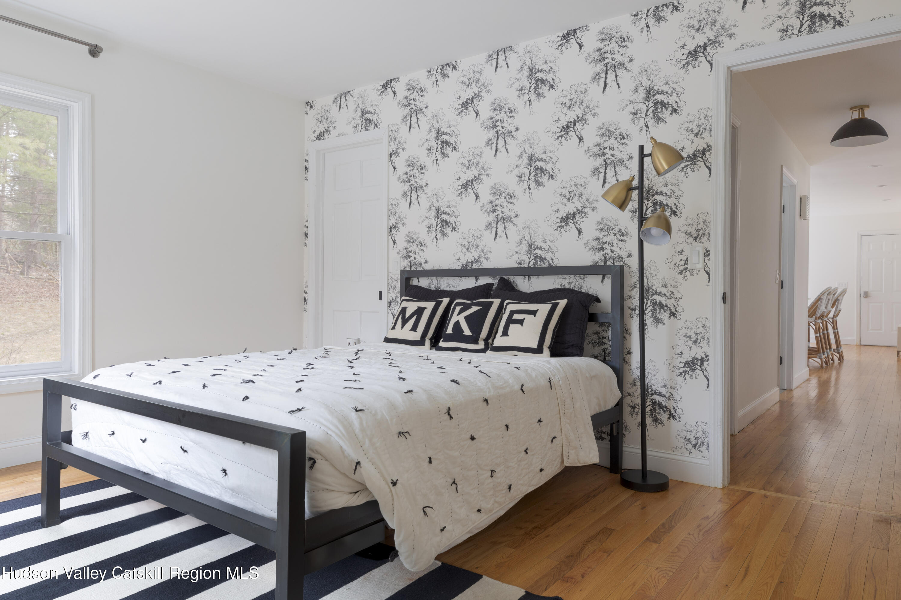 79 Stillwater Road Stone Ridge, NY 12484 - Photo 14 of 29 a bedroom with a bed and wooden floor