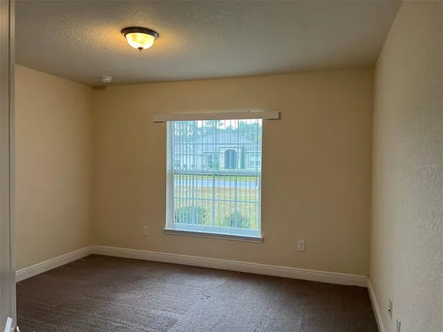 a view of a hallway with a wooden door