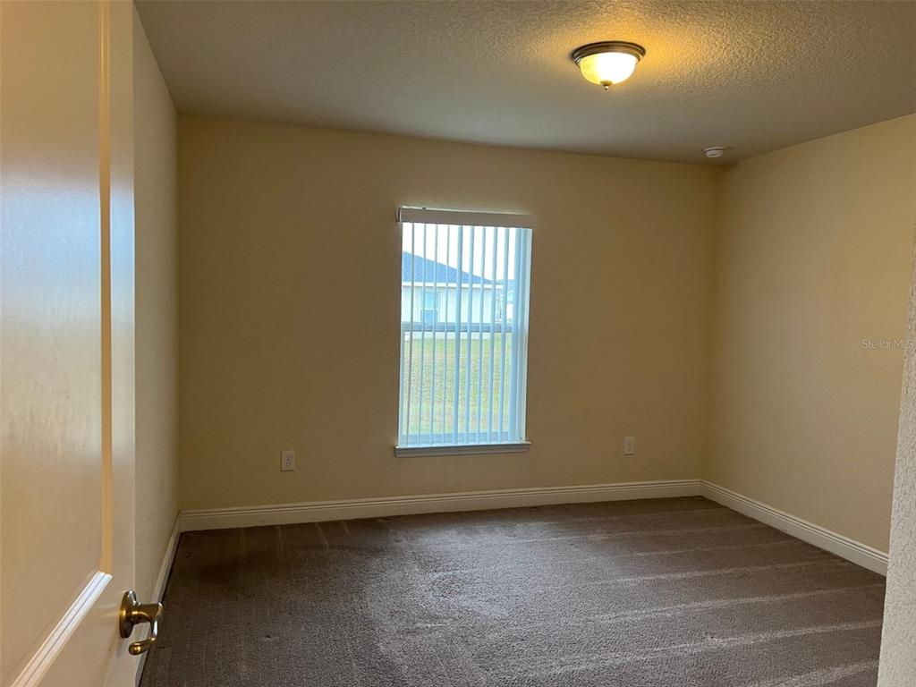 9883 Southwest 55th Ave Road Ocala, FL 34476 - Photo 25 of 30 an empty room with a window