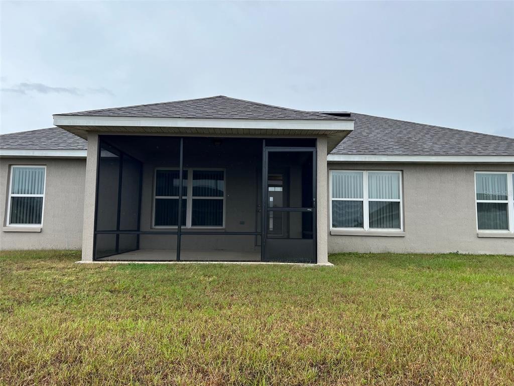 9883 Southwest 55th Ave Road Ocala, FL 34476 - Photo 30 of 30 a front view of a house with a garden
