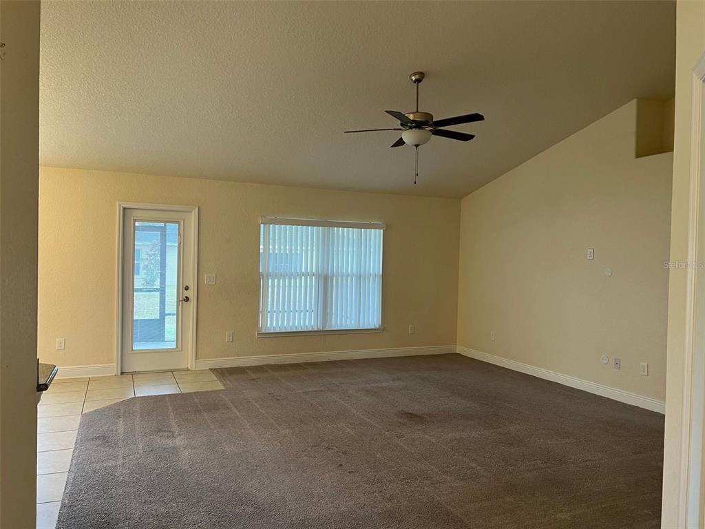 9883 Southwest 55th Ave Road Ocala, FL 34476 - Photo 3 of 30 an empty room with windows and fan