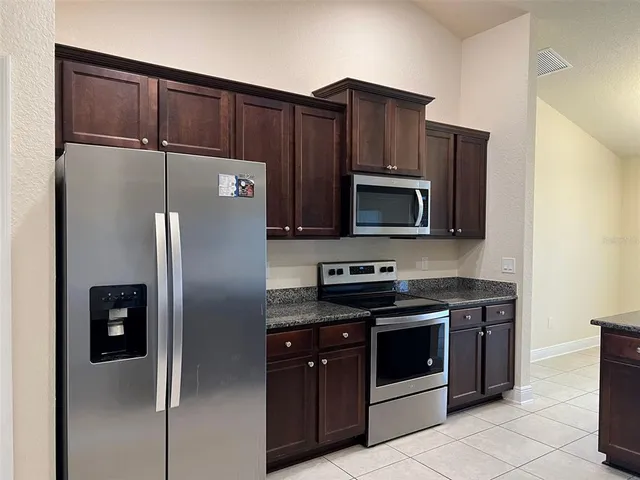 a kitchen with stainless steel appliances and cabinets