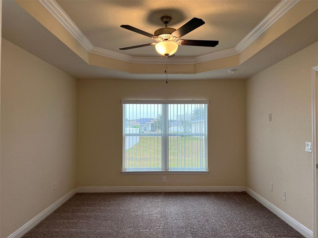 9883 Southwest 55th Ave Road Ocala, FL 34476 - Photo 10 of 30 an empty room with ceiling fan and window