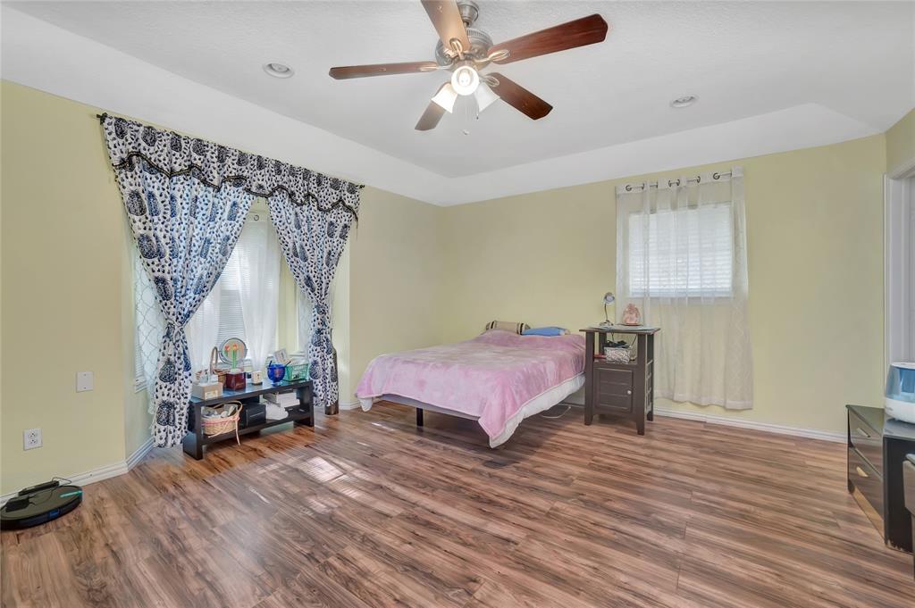 6021 Sycamore Creek Road Edgecliff Village, TX 76134 - Photo 16 of 37 a spacious bedroom with a bed and a chandelier