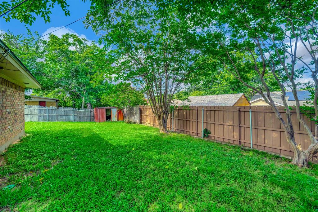 6021 Sycamore Creek Road Edgecliff Village, TX 76134 - Photo 33 of 37 a view of a backyard with a small cabin and wooden fence