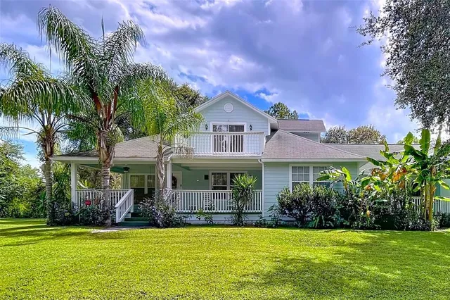 a front view of a house with a garden and plants