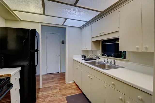 a kitchen with a sink and cabinets