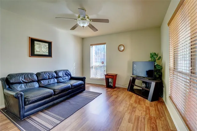 a living room with furniture and a wooden floor
