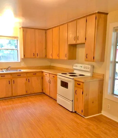 a view of a kitchen with wooden floor