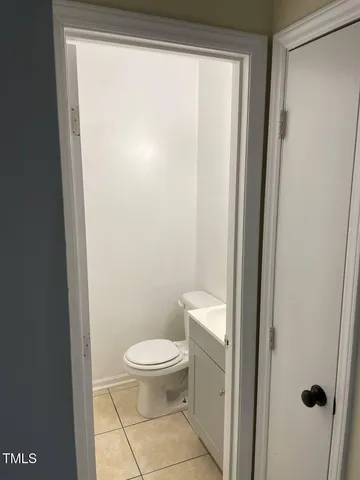 a white toilet sitting next to a shower