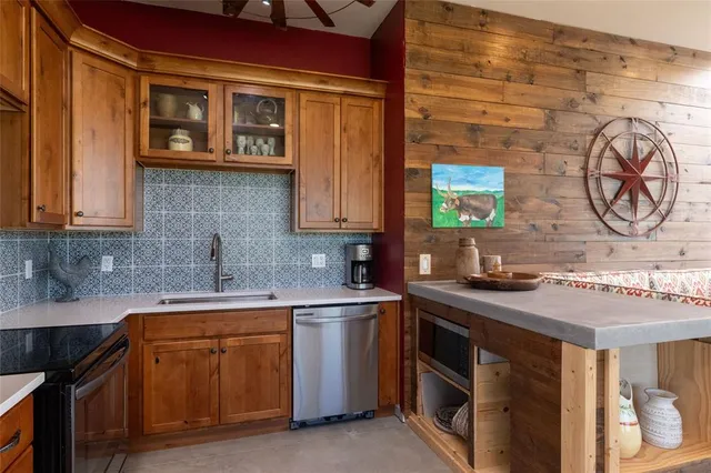 a kitchen with stainless steel appliances granite countertop a sink and cabinets