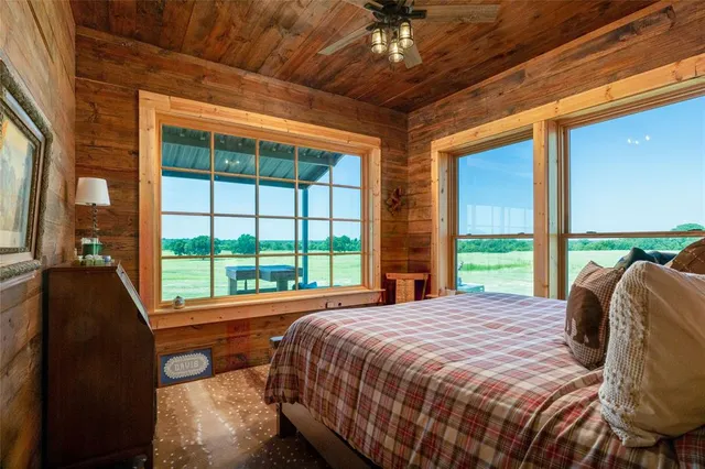a bed sitting in a bedroom next to a large window