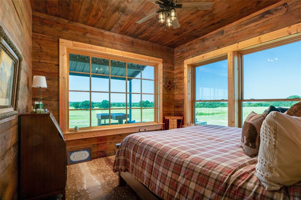 1370 Parker Dairy Road Forestburg, TX 76239 - Photo 14 of 35 a bed sitting in a bedroom next to a large window