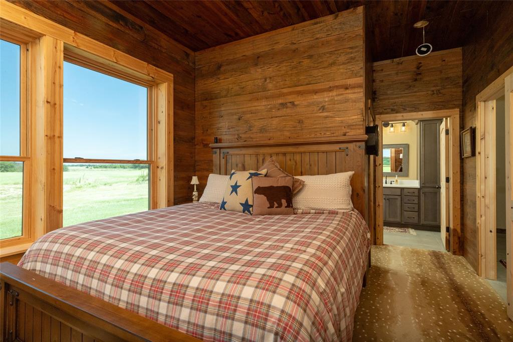 1370 Parker Dairy Road Forestburg, TX 76239 - Photo 15 of 35 a large bed sitting in a bedroom next to a window