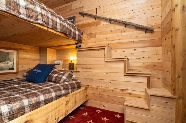 a bed room with a bed and a chair