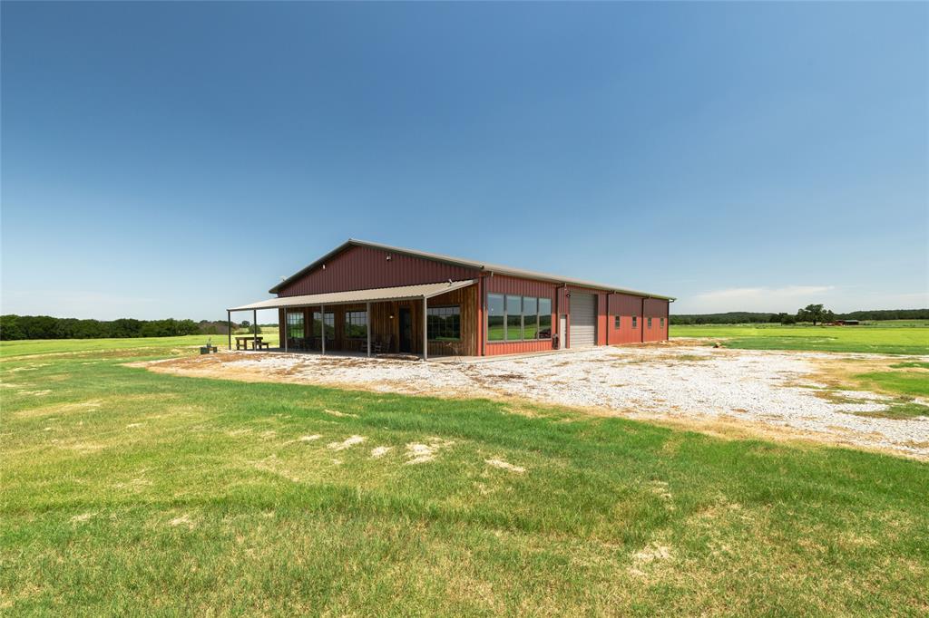 1370 Parker Dairy Road Forestburg, TX 76239 - Photo 4 of 35 a house with a garden and swimming pool