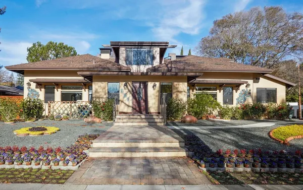a view of a house with swimming pool and a yard