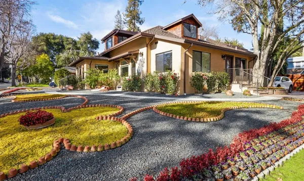 a front view of a house with a garden and porch
