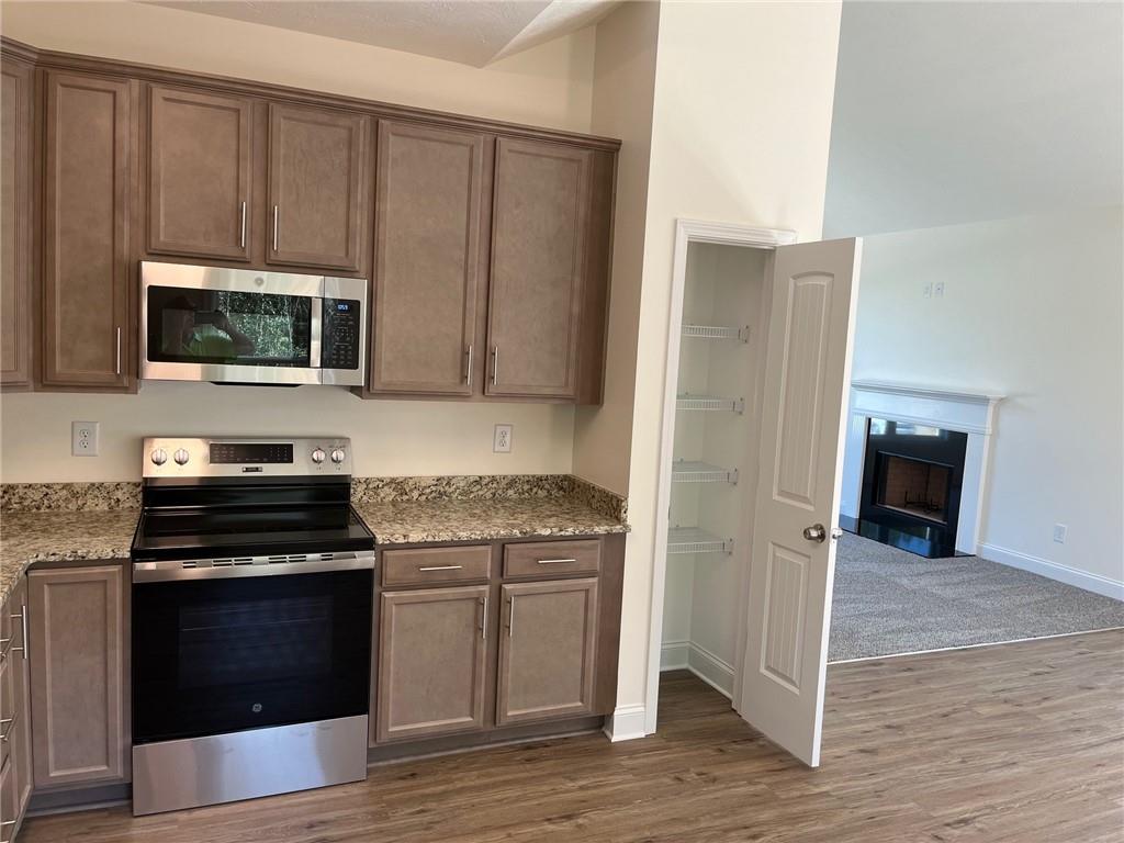 202 Gamel Road Dallas, GA 30157 - Photo 10 of 34 a kitchen with granite countertop a stove and a microwave