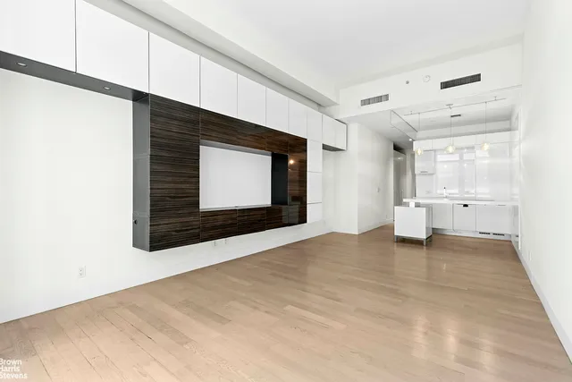 a view of an empty room with a fireplace and a window