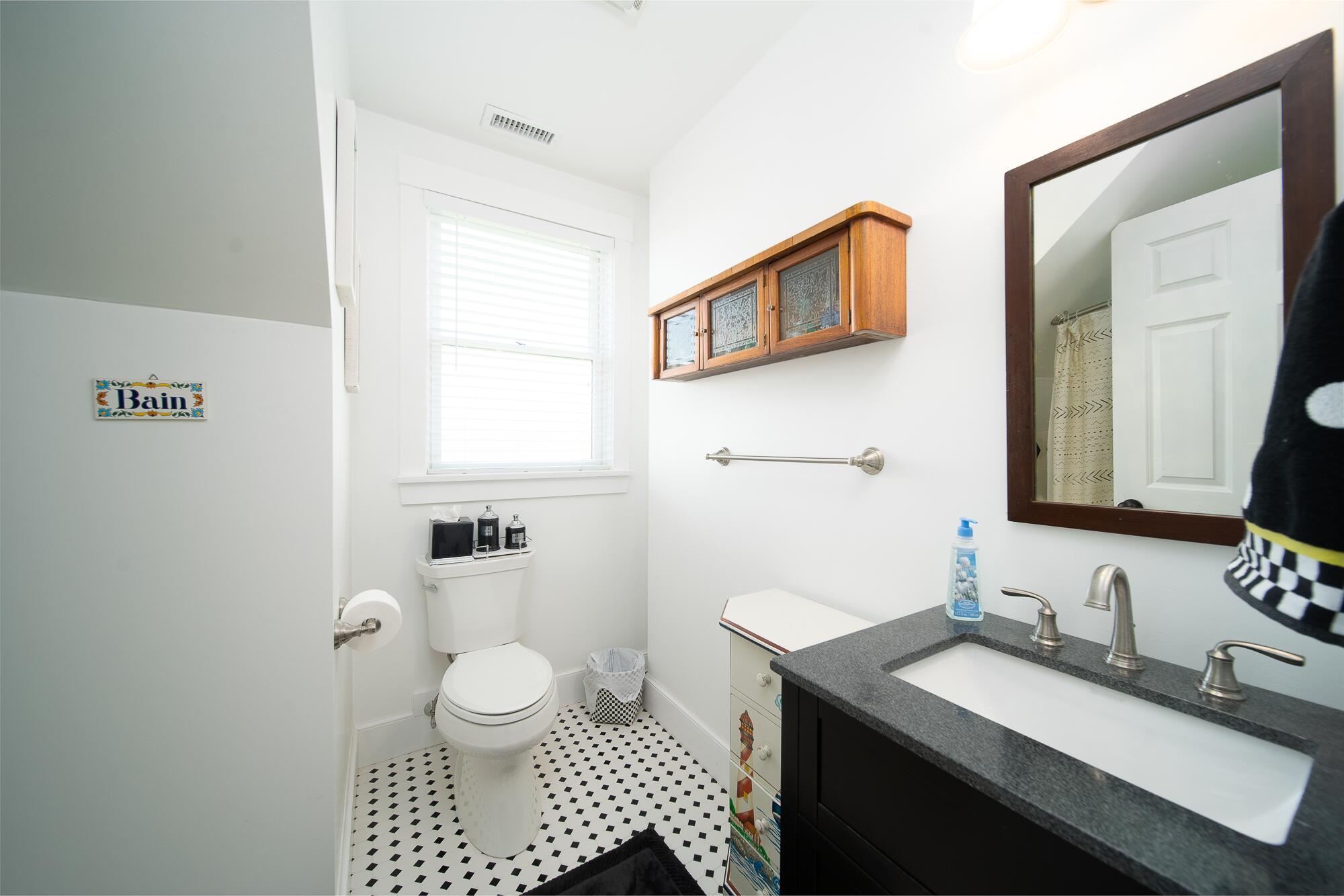 27 Watcha Path Edgartown, MA 02539 - Photo 15 of 24 a bathroom with a sink a toilet and a mirror