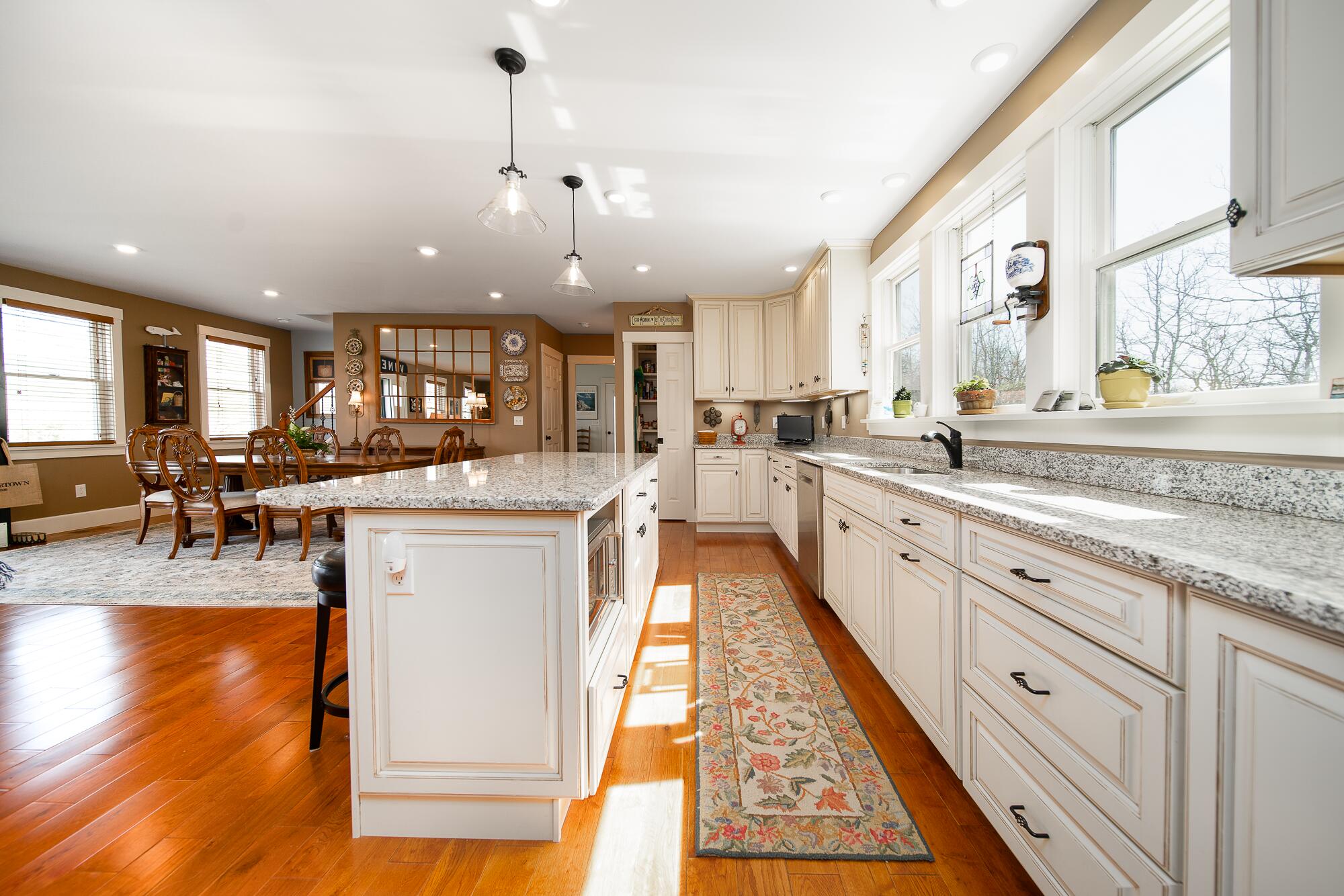 27 Watcha Path Edgartown, MA 02539 - Photo 4 of 24 a large white kitchen with lots of counter space wooden floor and appliances