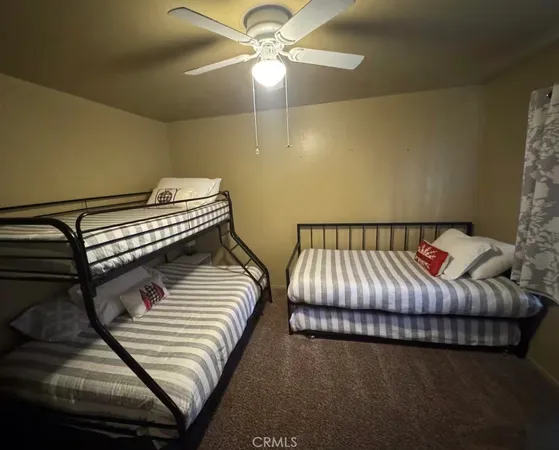 a bedroom with bed and a chandelier