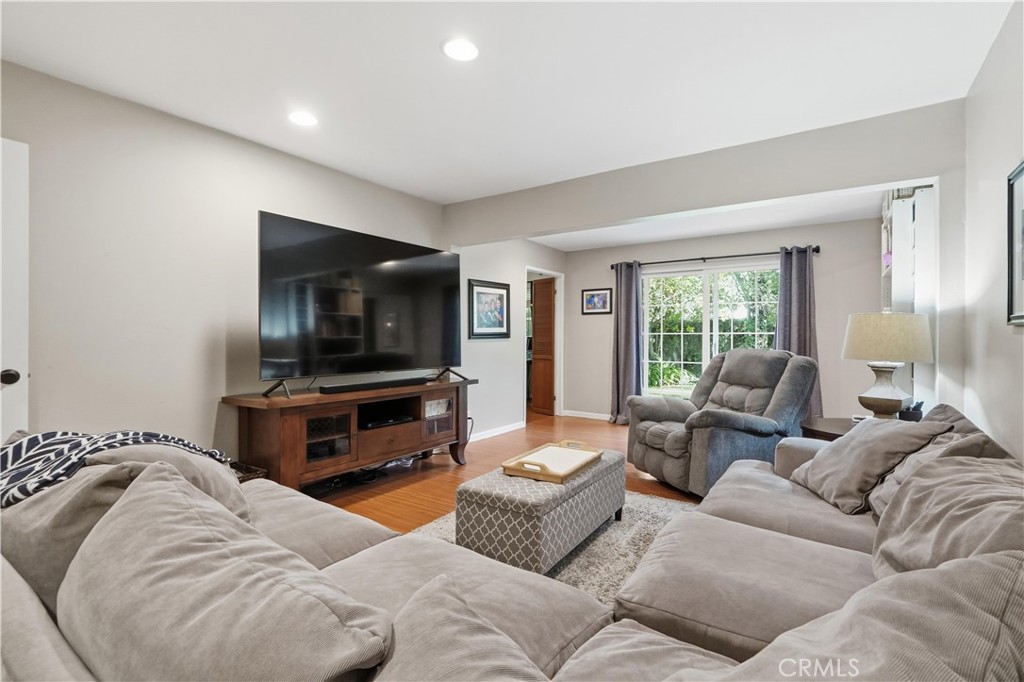 10808 Des Moines Avenue Porter Ranch, CA 91326 - Photo 11 of 39 a living room with furniture and a flat screen tv