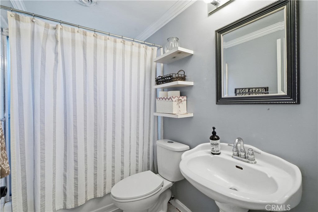 10808 Des Moines Avenue Porter Ranch, CA 91326 - Photo 14 of 39 a bathroom with a sink a toilet and mirror