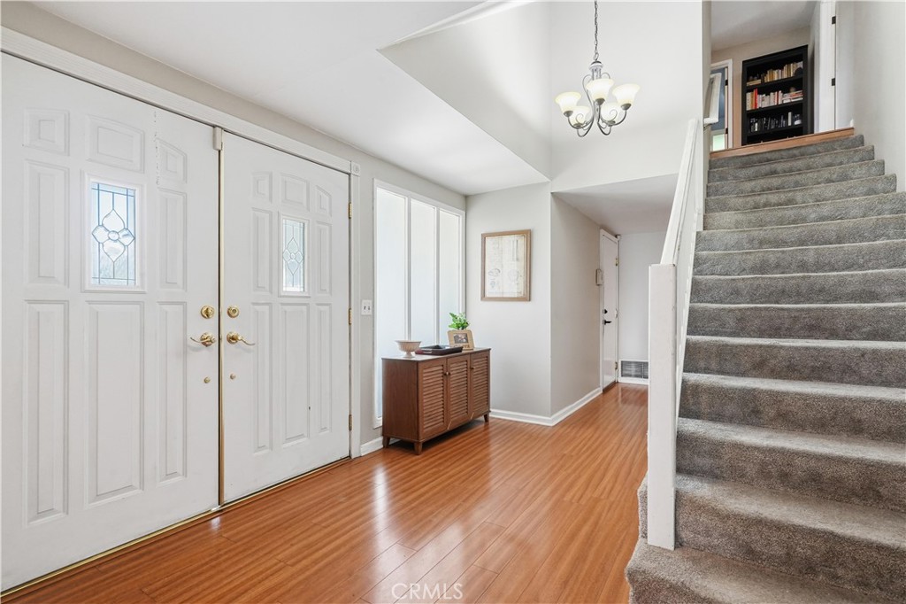 10808 Des Moines Avenue Porter Ranch, CA 91326 - Photo 16 of 39 a view of a hallway with wooden floor and staircase