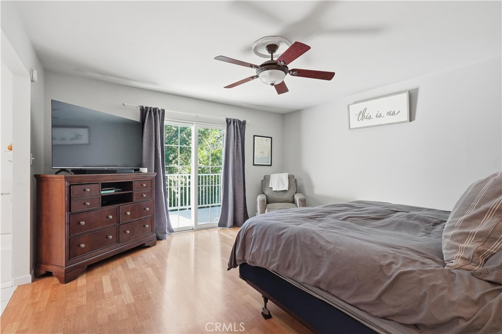 10808 Des Moines Avenue Porter Ranch, CA 91326 - Photo 20 of 39 a bedroom with a bed and a flat tv screen on dresser