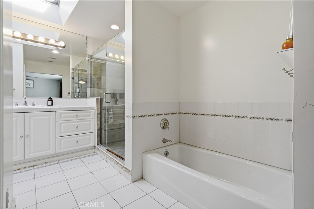 10808 Des Moines Avenue Porter Ranch, CA 91326 - Photo 21 of 39 a bathroom with a bathtub a sink a vanity and a mirror