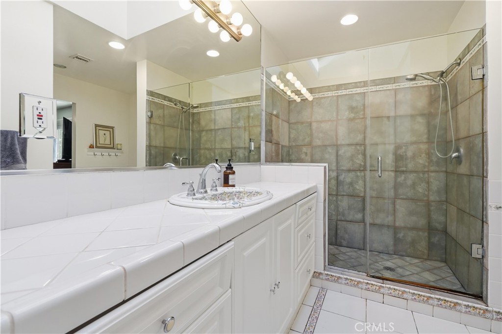 10808 Des Moines Avenue Porter Ranch, CA 91326 - Photo 22 of 39 a bathroom with a sink shower and a mirror