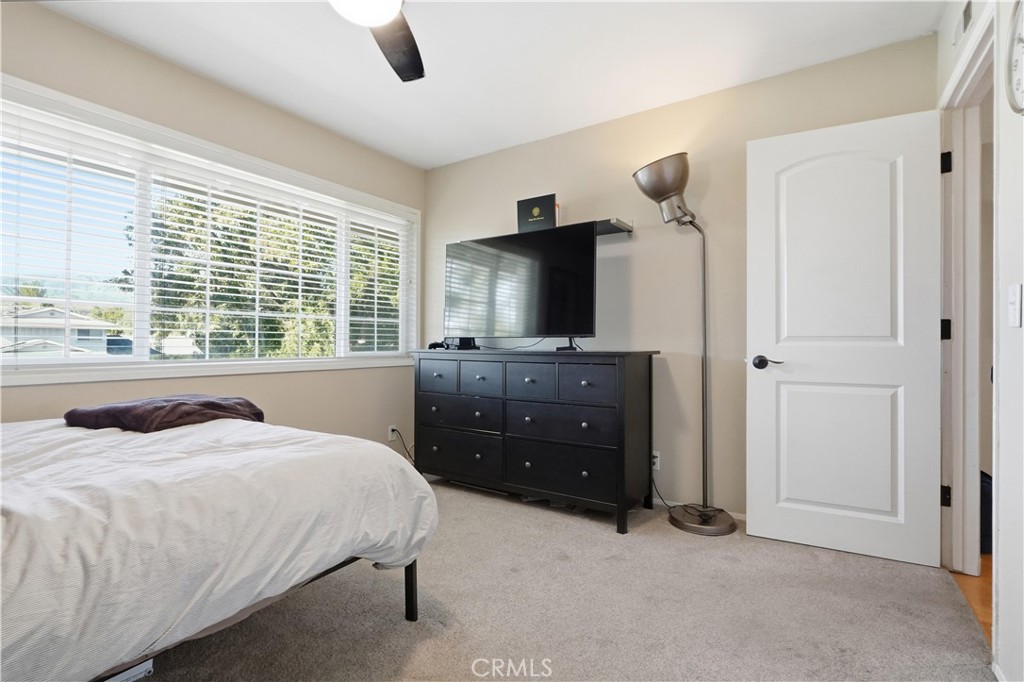 10808 Des Moines Avenue Porter Ranch, CA 91326 - Photo 27 of 39 a bedroom with a bed and a flat tv screen on dresser