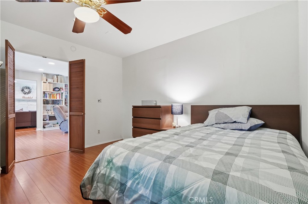 10808 Des Moines Avenue Porter Ranch, CA 91326 - Photo 28 of 39 a bedroom with a bed and wooden floor