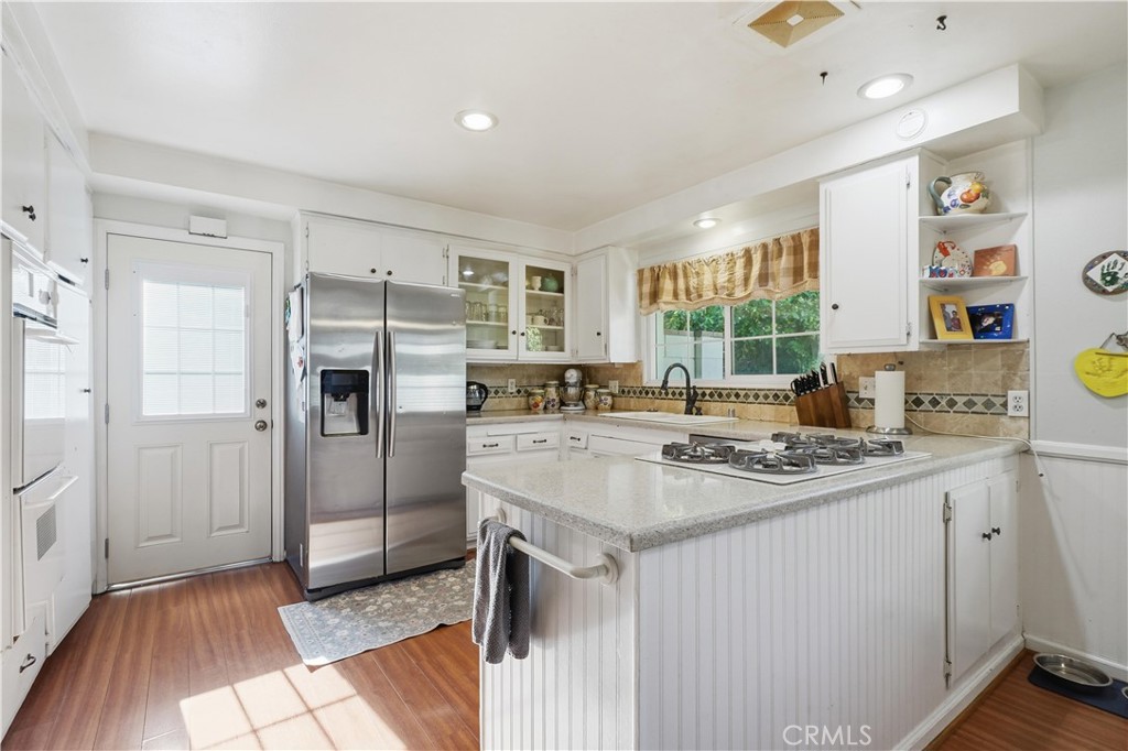 10808 Des Moines Avenue Porter Ranch, CA 91326 - Photo 7 of 39 a kitchen with stainless steel appliances granite countertop a sink stove and refrigerator